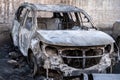 Closeup of burnt-out car completely destroyed due to arson during demonstrations. Vandalism concept Royalty Free Stock Photo