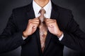 Closeup of business man fixing his neck tie Royalty Free Stock Photo