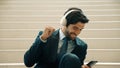 Closeup of business man listen and enjoy music while wear headphone. Exultant. Royalty Free Stock Photo