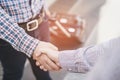 Closeup of a business man with luggage travel hand shake between two colleagues greet Royalty Free Stock Photo