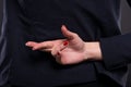 Closeup of business woman with crossed fingers