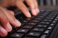 Closeup of business woman hand typing on laptop keyboard