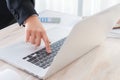 Closeup of business woman hand typing on laptop keyboard.