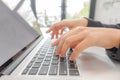 Closeup of business woman hand typing on laptop keyboard .