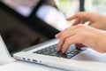 Closeup of business woman hand typing on laptop keyboard .