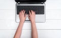 Closeup of business woman hands with short nails typing on open laptop Royalty Free Stock Photo