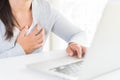 Closeup business woman having heart attack. Woman touching breast and having chest pain after long hours work on computer. Office Royalty Free Stock Photo