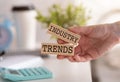 Closeup on business woman holding a wooden block with Industry trends message, business concept