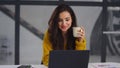 Closeup business woman looking laptop. Smiling girl drinking tea near notebook Royalty Free Stock Photo