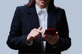 Closeup of business woman& x27;s hands using smartphone, on gray background Royalty Free Stock Photo