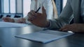 Closeup businessman hand holding pen reading contract agreement in office. Royalty Free Stock Photo