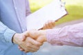 Closeup of a businessman hand shake businesswoman between two colleagues OK, succeed Royalty Free Stock Photo