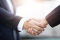 Closeup of a businessman hand shake businesswoman between two colleagues Royalty Free Stock Photo