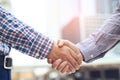 Closeup of a businessman hand shake between two colleagues  OK, succeed in business Holding hands. Royalty Free Stock Photo