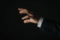 Closeup of businessman hand touching virtual digital interface on dark background Royalty Free Stock Photo