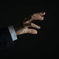 Closeup of businessman hand touching virtual digital interface on dark background Royalty Free Stock Photo
