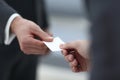 Businessman handing business card to the partner. Royalty Free Stock Photo