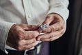 Closeup businessman hands with cufflinks. Man in a business suit, white shirt. Preparing the groom on the wedding day Royalty Free Stock Photo