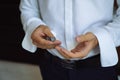 Closeup businessman hands with cufflinks. Man in a business suit, white shirt. Preparing the groom on the wedding day Royalty Free Stock Photo