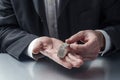 Closeup on businessman hands displaying precious metal jewel for concept of gold and money in hands