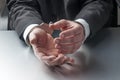 Closeup on businessman hands with handcuffs on for concept of crime or justice at work