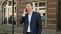 Closeup businessman having phone talk at street. man talking phone outdoors Royalty Free Stock Photo