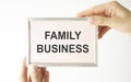 card with text FAMILY BUSINESS, business concept image with soft focus background Royalty Free Stock Photo