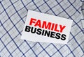 Closeup on businessman holding a card with text FAMILY BUSINESS Royalty Free Stock Photo