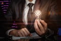 A closeup of a businessman holding an idea symbol lightbulb with cogwheel and currency unit mechanism Royalty Free Stock Photo