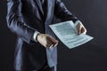 Closeup of a businessman holding a pen and a document with the terms of the contract. Royalty Free Stock Photo