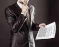 Closeup of a businessman holding a pen and a document with the terms of the contract. Royalty Free Stock Photo