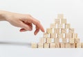 Closeup of businessman making a pyramid with empty wooden cubes Royalty Free Stock Photo