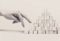 Closeup of businessman making a pyramid with empty wooden cubes Royalty Free Stock Photo