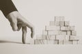 Closeup of businessman making a pyramid with empty wooden cubes Royalty Free Stock Photo