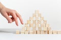 Closeup of businessman making a pyramid with empty wooden cubes Royalty Free Stock Photo