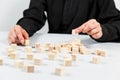 Closeup of businessman making a pyramid with empty wooden cubes Royalty Free Stock Photo