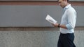 Closeup businessman reading papers outdoor. Man throwing documents at street Royalty Free Stock Photo