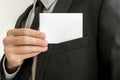 Closeup of businessman removing a blank business card from the p