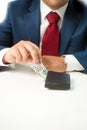 Closeup of businessman stealing money from the wallet Royalty Free Stock Photo