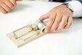 Closeup of businessman taking money out of mousetrap Royalty Free Stock Photo