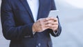 Closeup of businessman using cellphone in heart of city Royalty Free Stock Photo