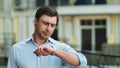 Closeup businessman waiting at street. Businessman checking time on wrist watch Royalty Free Stock Photo