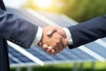 closeup businessmen handshake on solar panels background Royalty Free Stock Photo