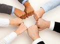 Closeup of businesspeople hands in fists in circle Royalty Free Stock Photo