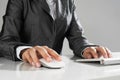 Closeup of businesswoman hand typing on keyboard with mouse on wood table Royalty Free Stock Photo