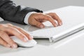 Closeup of businesswoman hand typing on keyboard with mouse on wood table Royalty Free Stock Photo