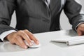 Closeup of businesswoman hand typing on keyboard with mouse on wood table Royalty Free Stock Photo