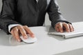 Closeup of businesswoman hand typing on keyboard with mouse on wood table Royalty Free Stock Photo