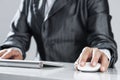 Closeup of businesswoman hand typing on keyboard with mouse on wood table Royalty Free Stock Photo