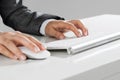 Closeup of businesswoman hand typing on keyboard with mouse on wood table Royalty Free Stock Photo